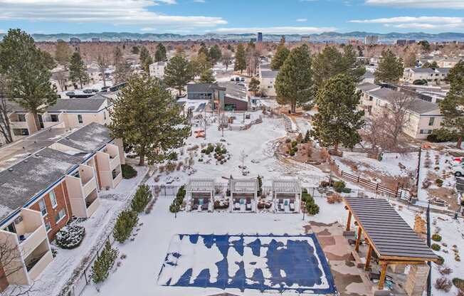 A snow-covered ground with a blue and white pattern in the middle of a courtyard.