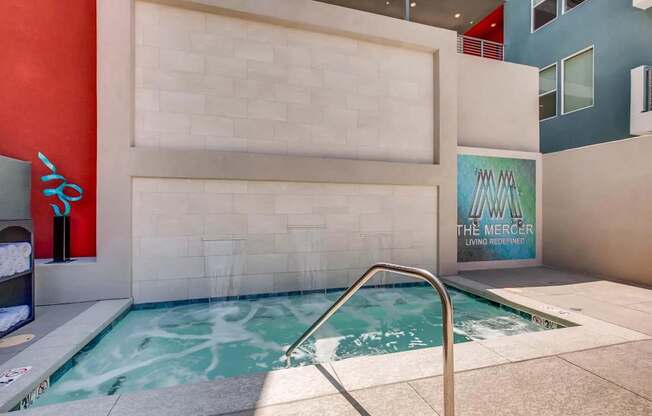 A pool with a sign that says "The Mercer Living Referrals".