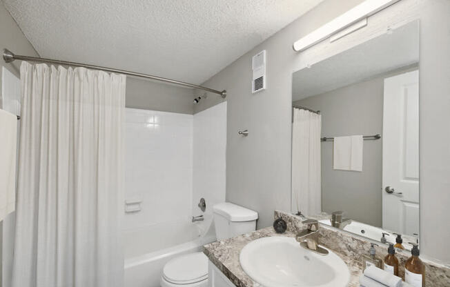 Model bathroom with a sink toilet and shower