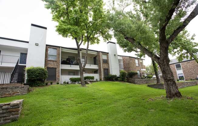 our apartments offer a green lawn and trees for residents to enjoy