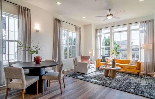 A modern dining room with a round table and chairs.