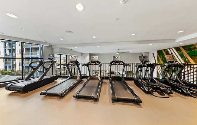A gym with treadmills and exercise bikes at Preston Ridge in Cary, NC.