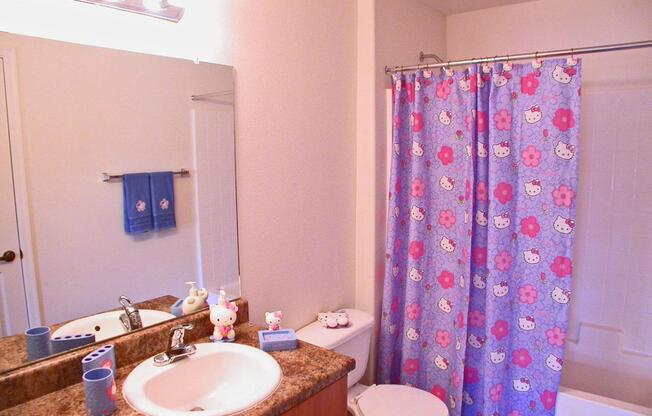 a shower curtain next to a sink