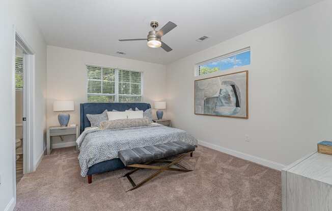 a bedroom with a bed and a ceiling fan