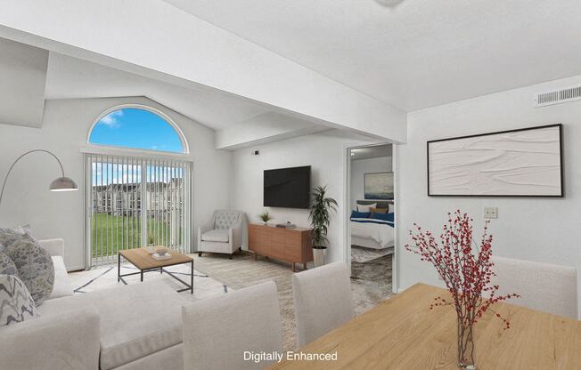 A living room with a cathedral ceiling at The Highlands Apartments in Elkhart, IN