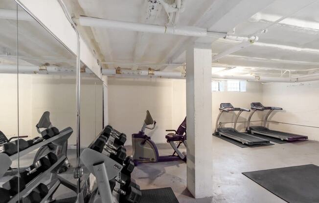 a gym with treadmills and other exercise equipment