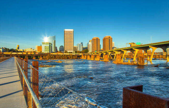 a view of a bridge over a river with a city in the background