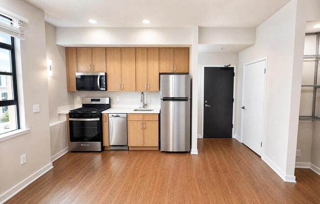 Open-concept dining and kitchen with updated lighting.