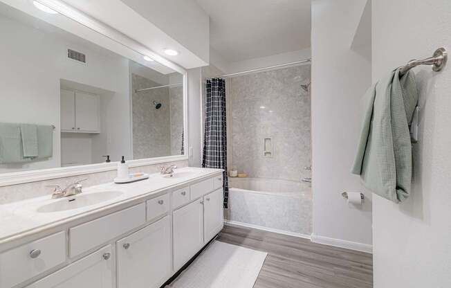 A white bathroom with a walk in shower.