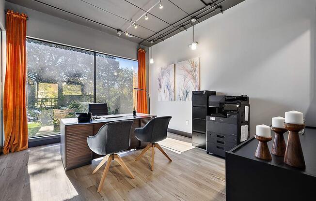 a home office with a desk and a large window at Troy Place Apartments - Troy, MI, Troy, Michigan