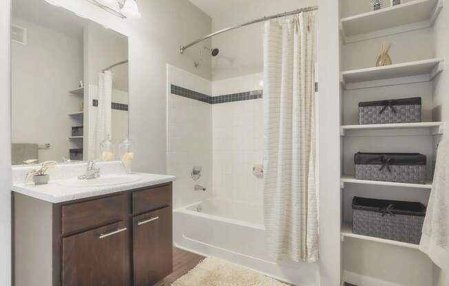 a bathroom with a shower and a sink and a mirror