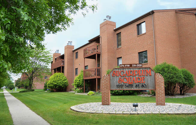 a large brick building with a sign in front of it