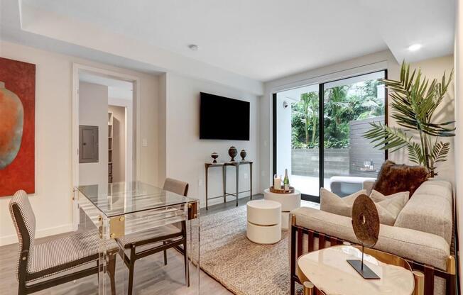 a living room with a glass table and a couch