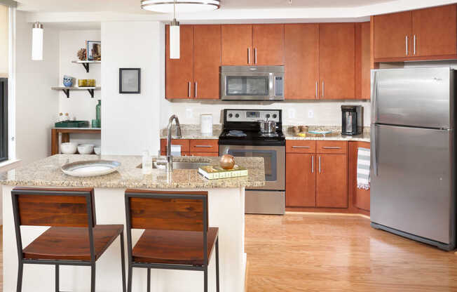 Island Kitchen with Stainless Steel Appliances, Cherrywood Cabinets and Hard Surface Flooring