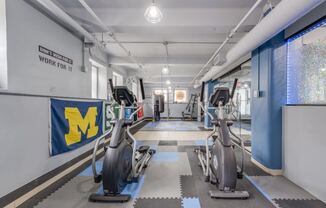 a gym with cardio machines and weight lifting at Lofts at 5 Lyon, in downtown Grand Rapids, MI