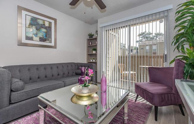 a living room filled with furniture and a large window