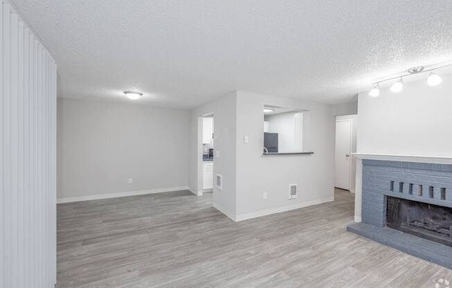 A living room with a fireplace and a television.