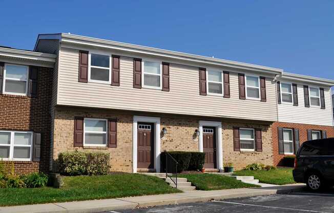 A row of houses with brown and beige siding.