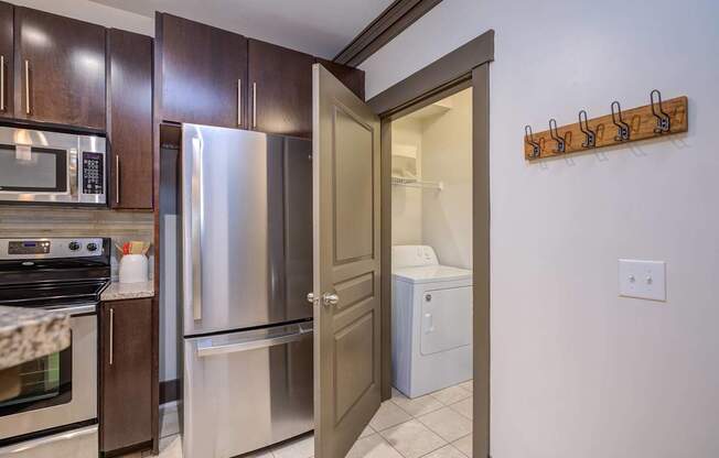 A kitchen with a stainless steel refrigerator and oven.