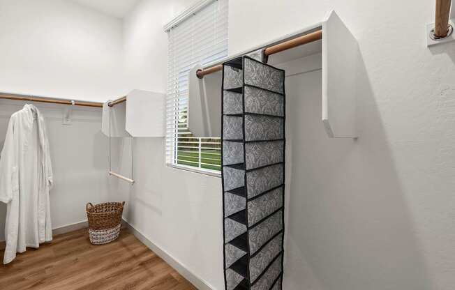 A white bathroom with a towel hanging on the wall.