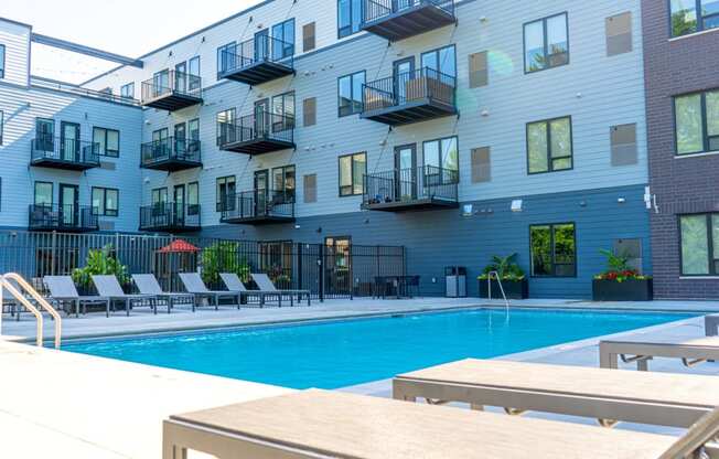 a swimming pool in front of an apartment building