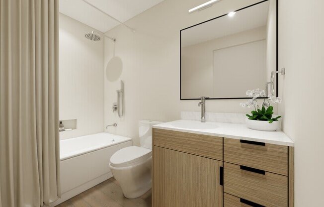 a modern bathroom with a large mirror at Lotus Republic Apartments for rent in Downtown Salt Lake City, Utah