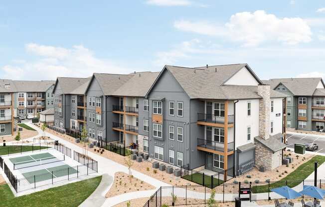 a rendering of an apartment building with a tennis court and pool