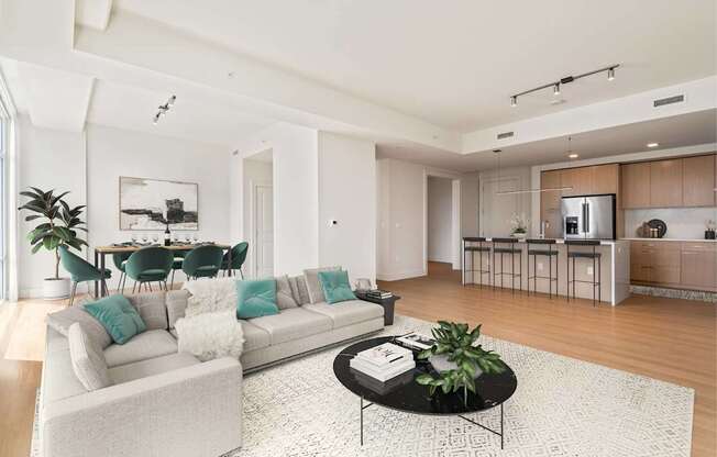 A modern living room with a white sofa and a coffee table.