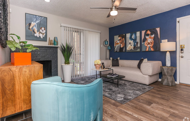 living room with accent wall, ceiling fan, and wood style flooring