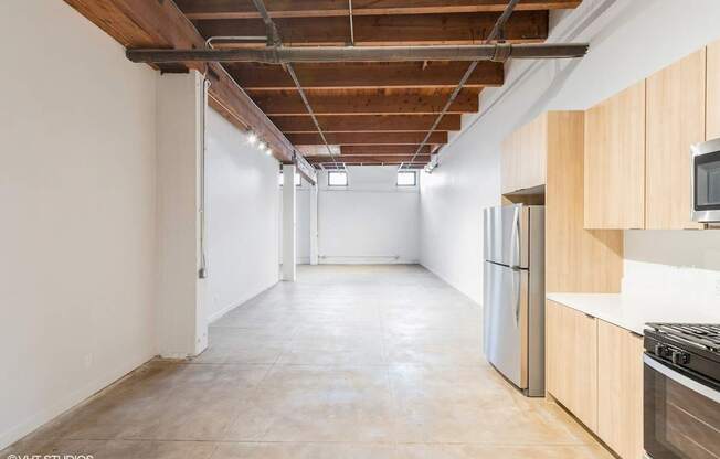 A spacious kitchen with wooden cabinets and stainless steel appliances.
