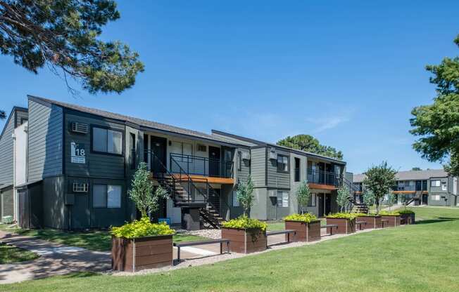 outside view of fusion fort worth apartment building with planter boxes and lawn