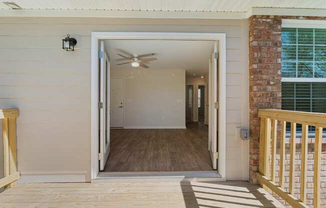 the view from the front porch of a house with a door open to a hallway