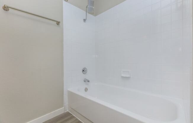 a bathroom with a bathtub and shower in a 555 waverly unit