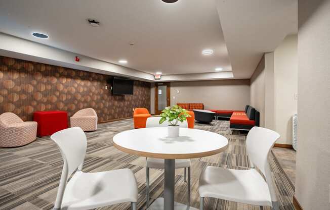 a meeting room with a round table and chairs. Fridley, MN Georgetown on the River Apartments