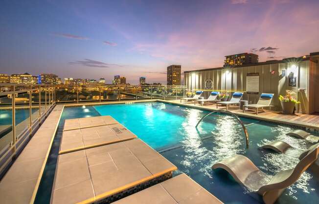 Rooftop pool facing downtown Dallas at night