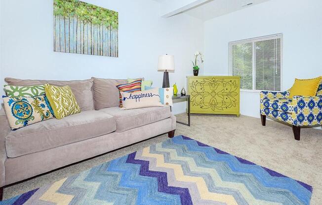 a living room with a couch and a rug