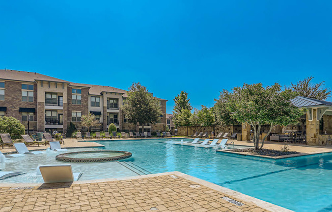 our apartments offer a swimming pool with chaise lounge chairs at Discovery at Craig Ranch, McKinney, 75070