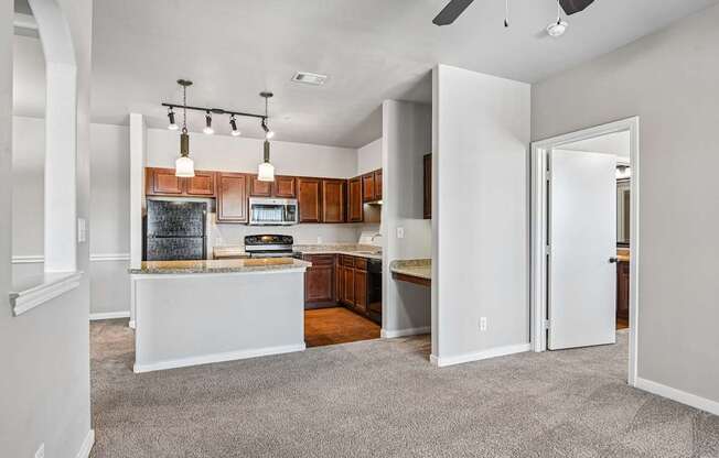 A kitchen with a white island and wooden cabinets.