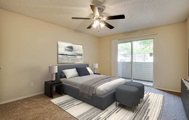 A bedroom with a bed, nightstand, and a ceiling fan.