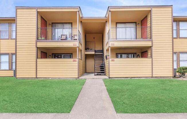 a house with a lawn in front of a building