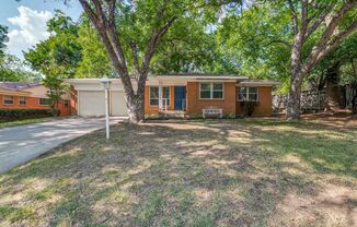 Updated home with a touch of vintage charm on a wooded lot. 3 bedrooms, 2 bathrooms, and 2 living areas.