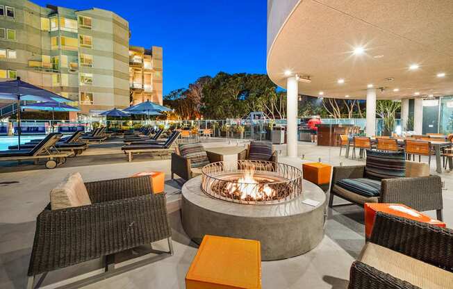 A fire pit sits in the middle of a patio with chairs around it at Esprit Marina del Rey, 90292