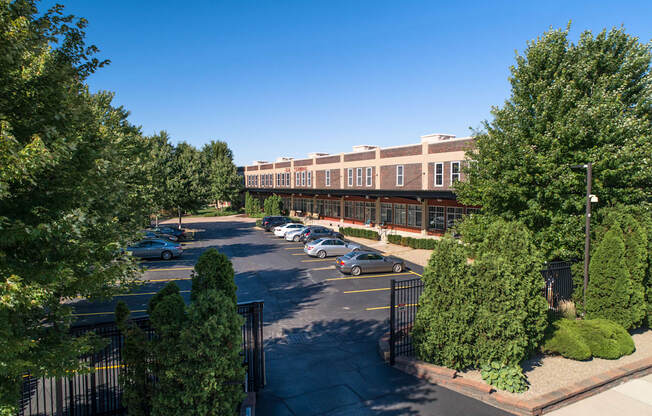 an aerial view of a building with cars parked in a parking lot at The Lofts at Elk Terminal, Buffalo, NY, New York, 14204