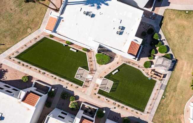 A large building with a green lawn in front.