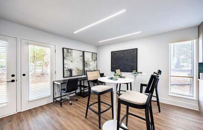an office with chairs and desks and a chalkboard on the wall