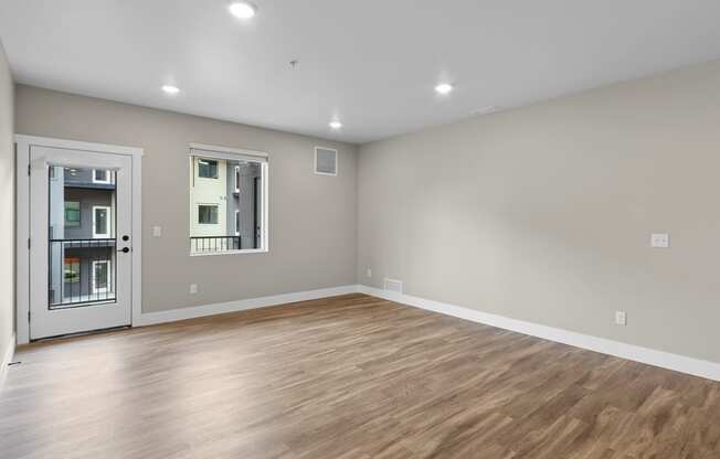 a bedroom with a hardwood floor and grey walls