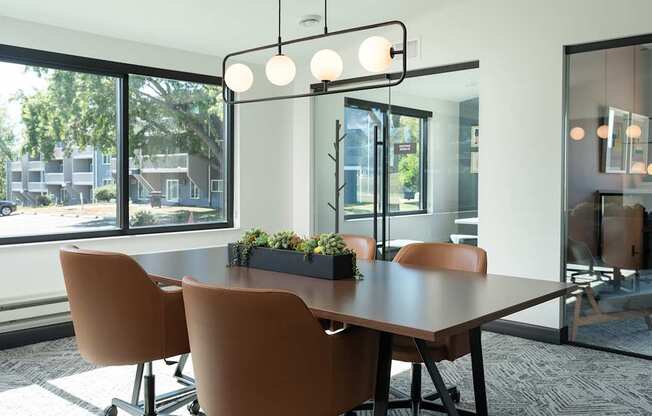 a conference room with a large window and a table with chairs