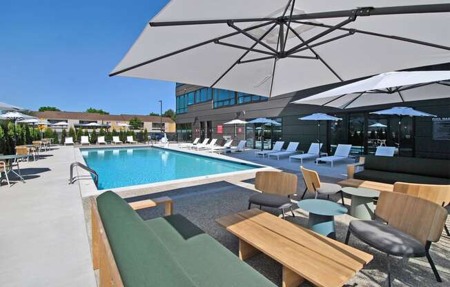 a swimming pool with lounge chairs and umbrellas at a hotel