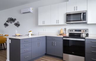 a kitchen with gray cabinets and a white countertop