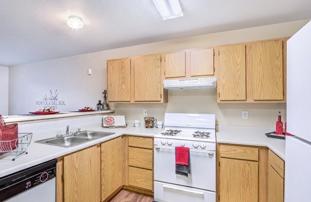 Apartments in North Las Vegas - Portola Del Sol - Kitchen with White Appliances and Wooden Cabinets